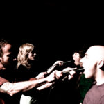 teeth shoving microphones in mouths